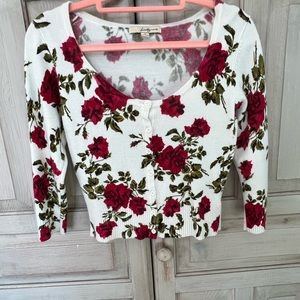 Cropped rose print cardigan.